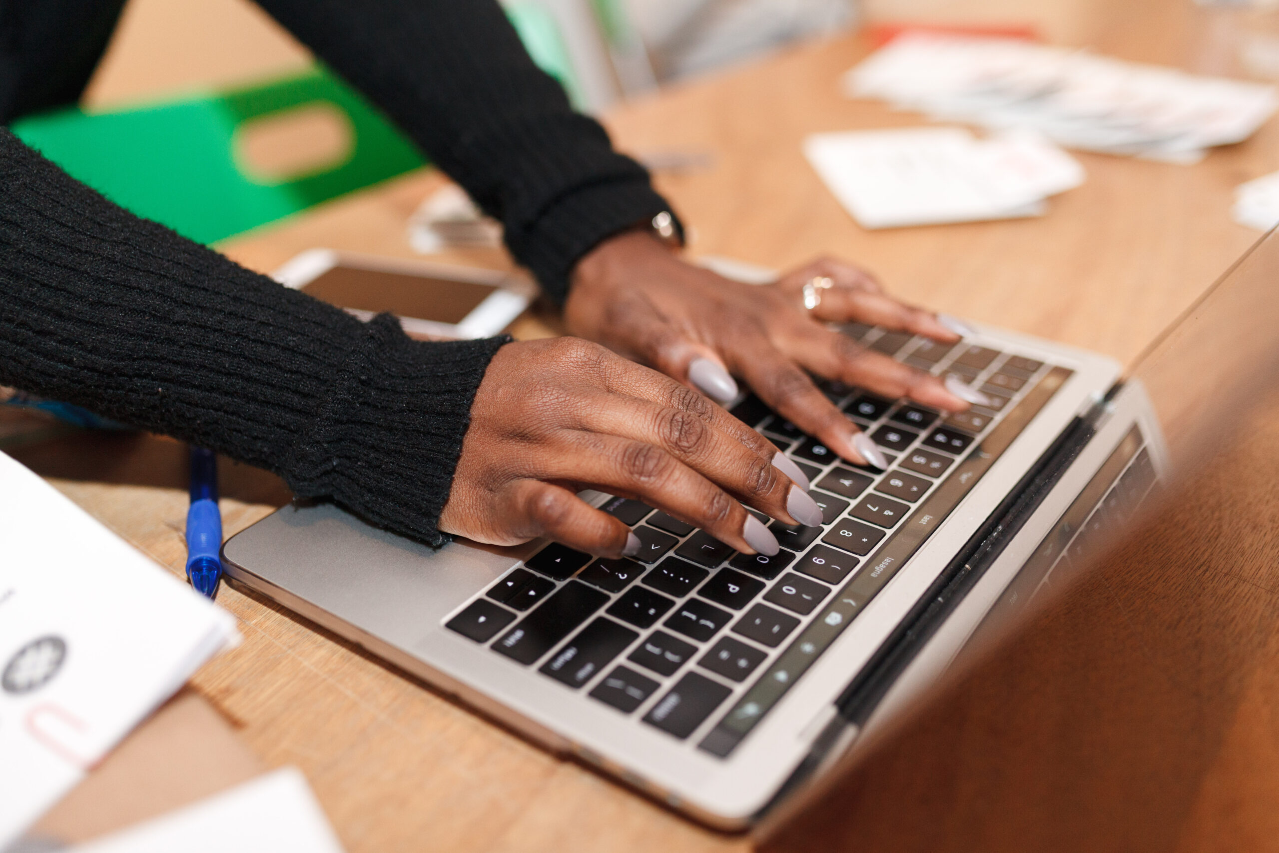 Close shot of female hands typing on laptop's keyboard