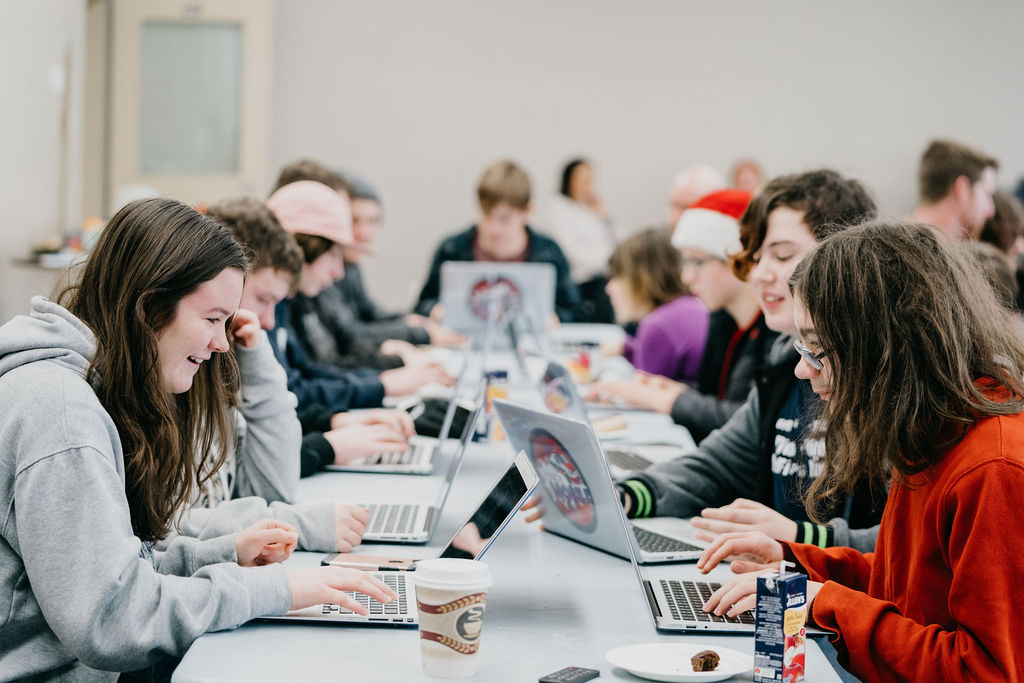 group of teens on laptops