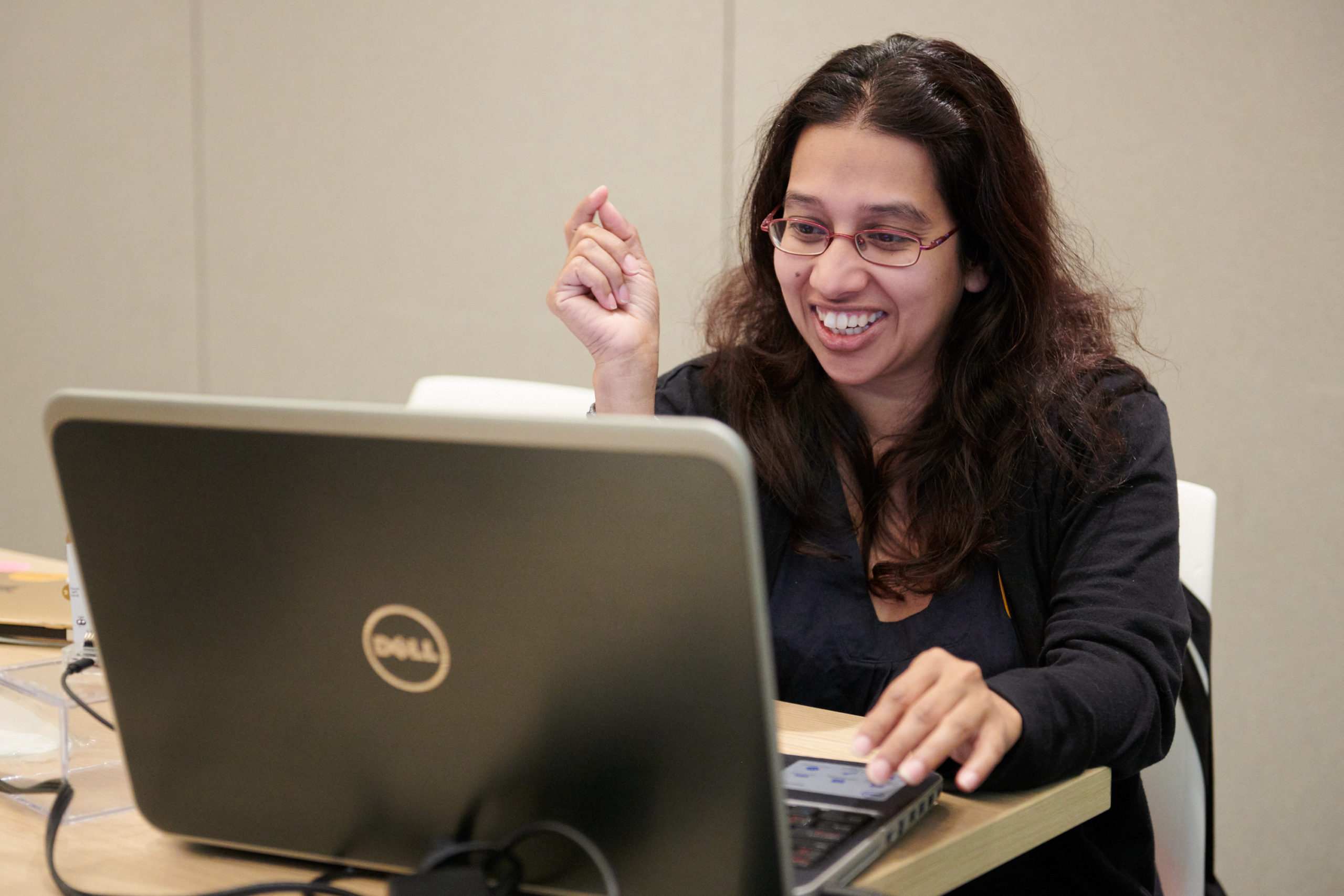 Woman smiling at laptop