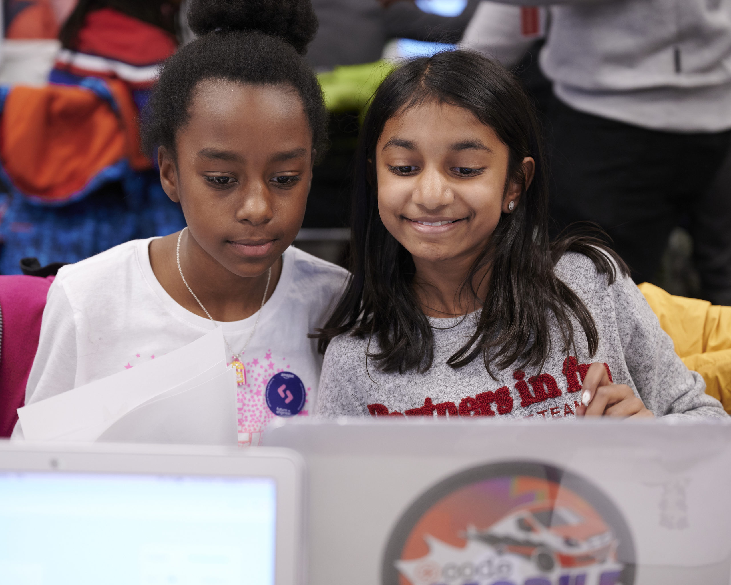 Two girls working on a laptop