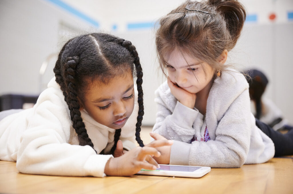 Two girls in front of the tablet 