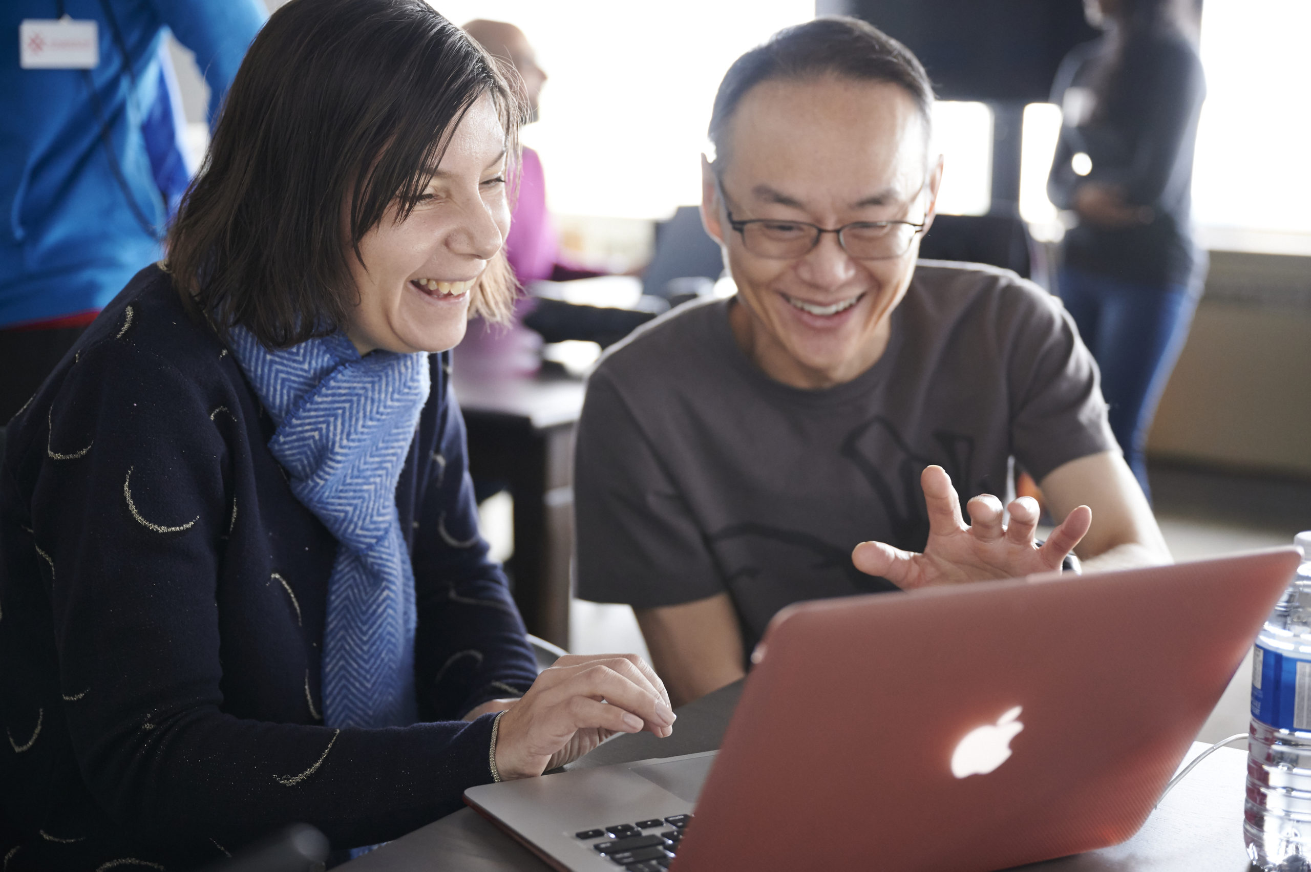 Woman and man sitting in front of laptop