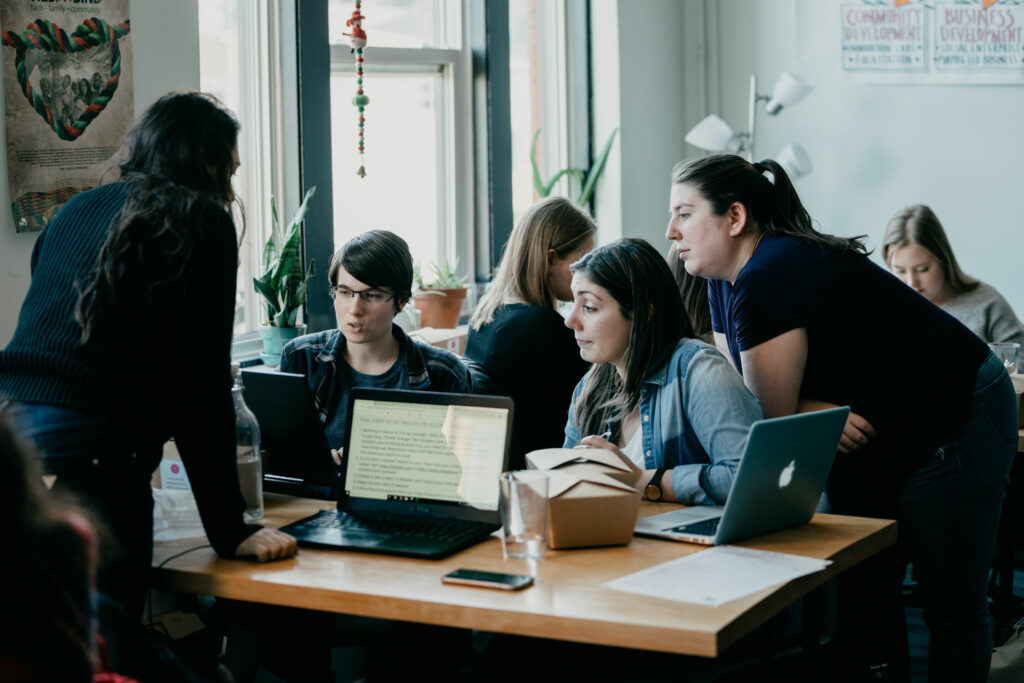 Group of adults working on a computer project