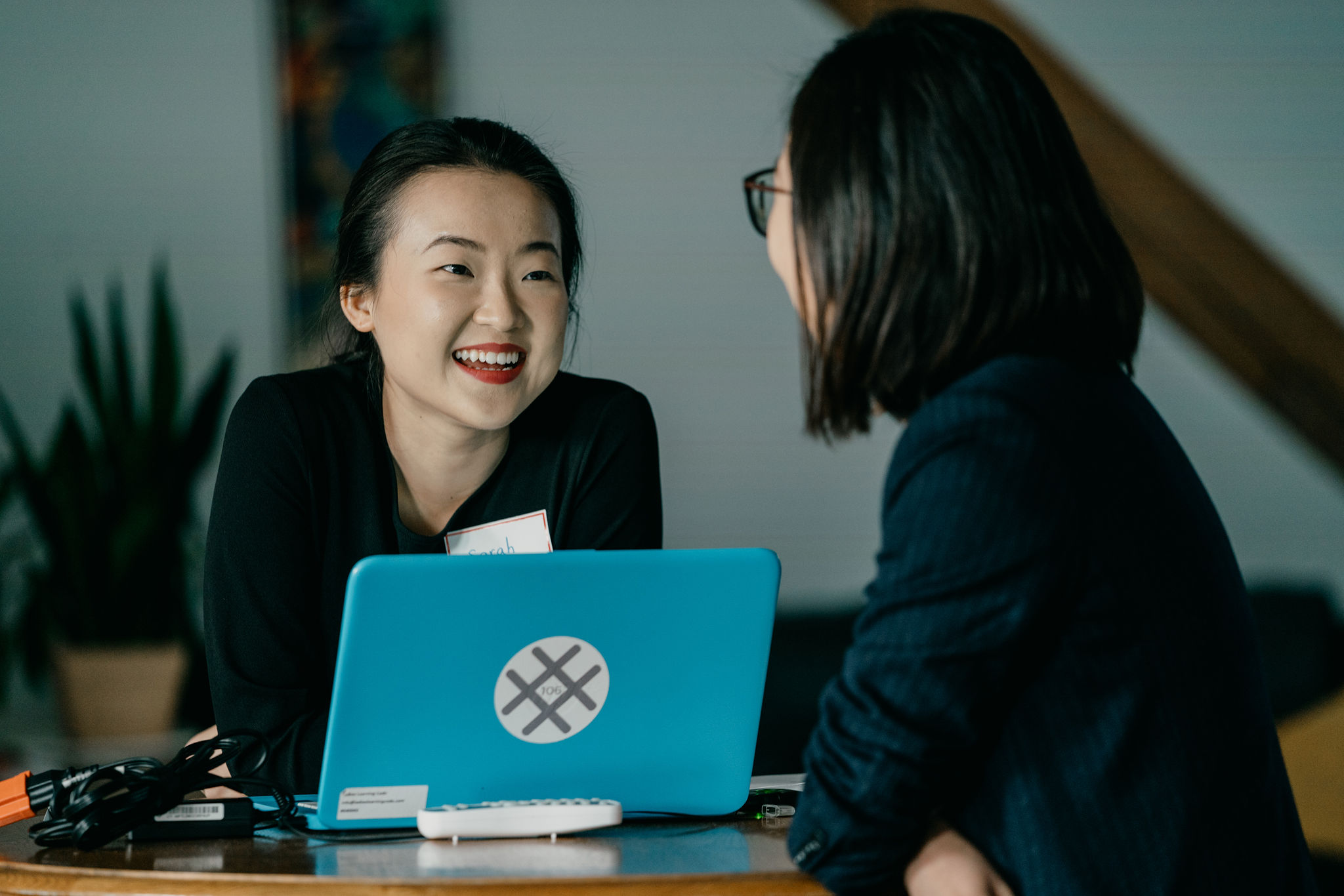 Two women chatting in front of a laptop