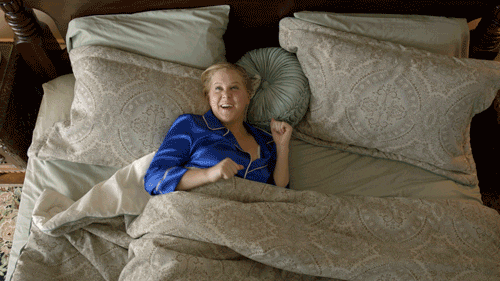 Woman waking up very excited.