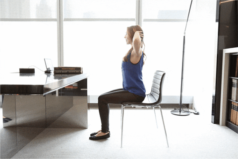 Woman doing an easy workout while sitting at her desk
